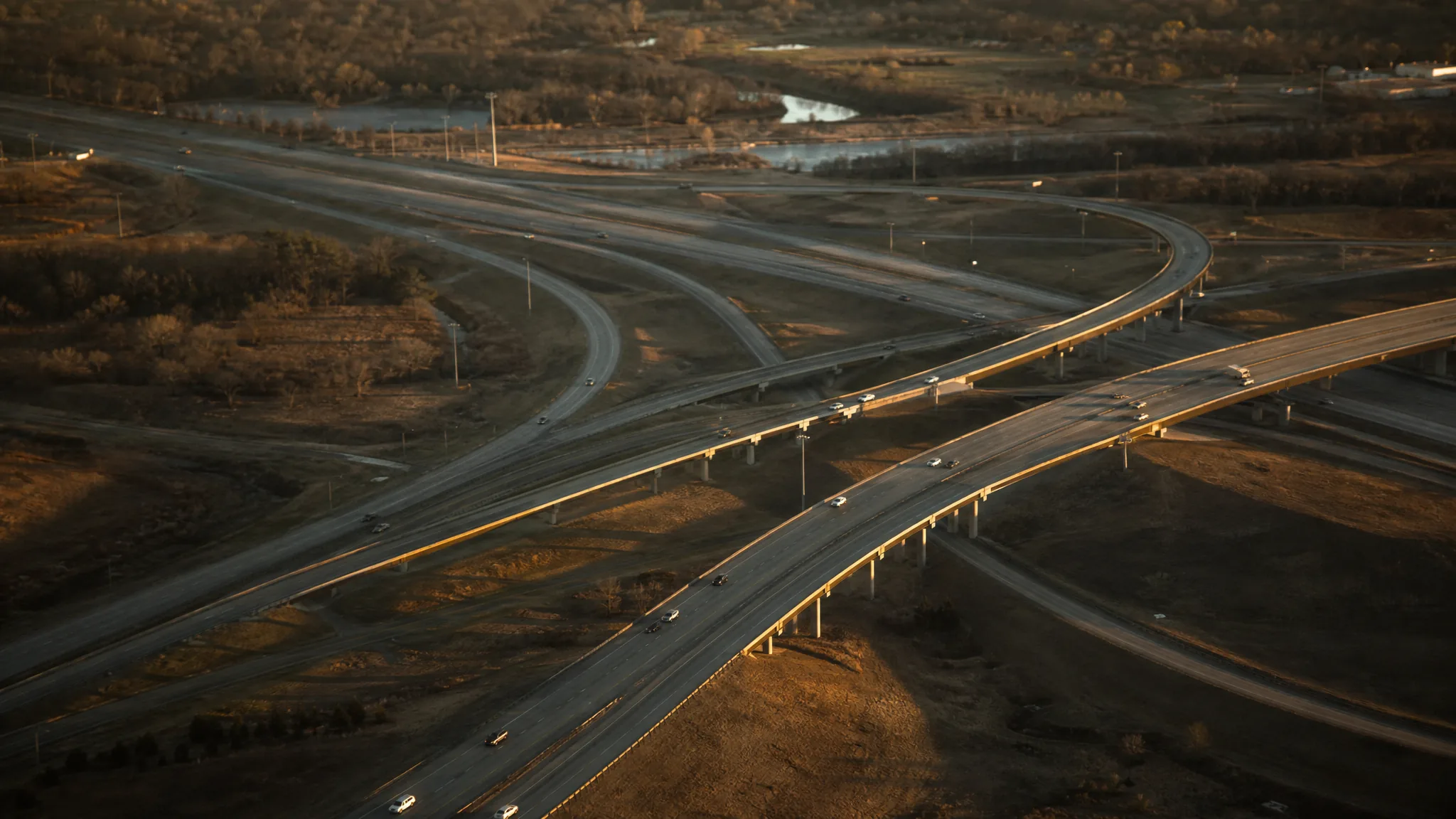 A US interstate highway interchange from the air at golden hour